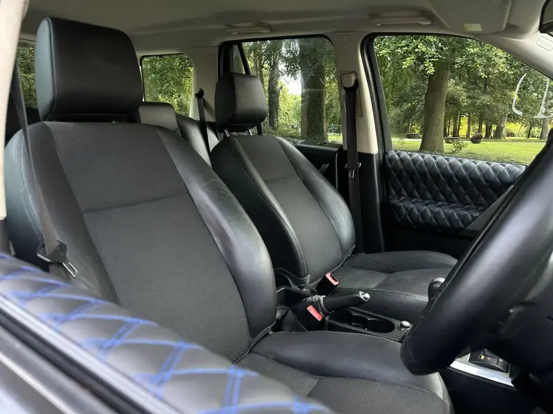 Diamond-quilted door card with blue contrast stitching